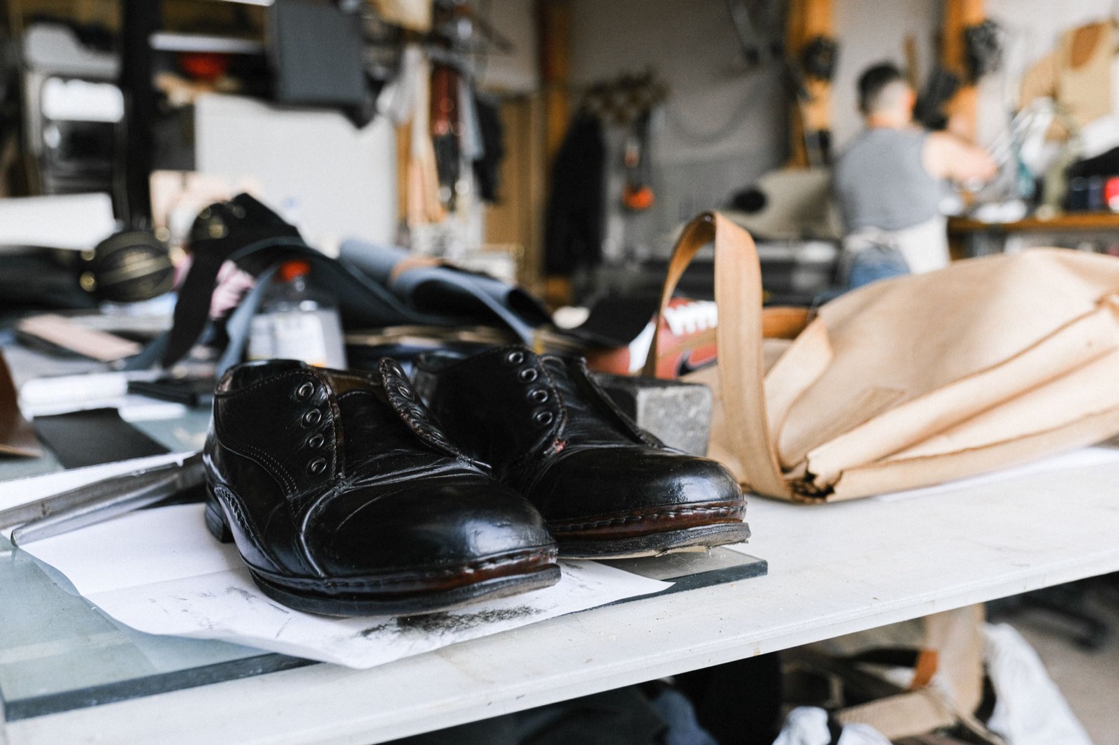 Black leather shoes on a maker's bench