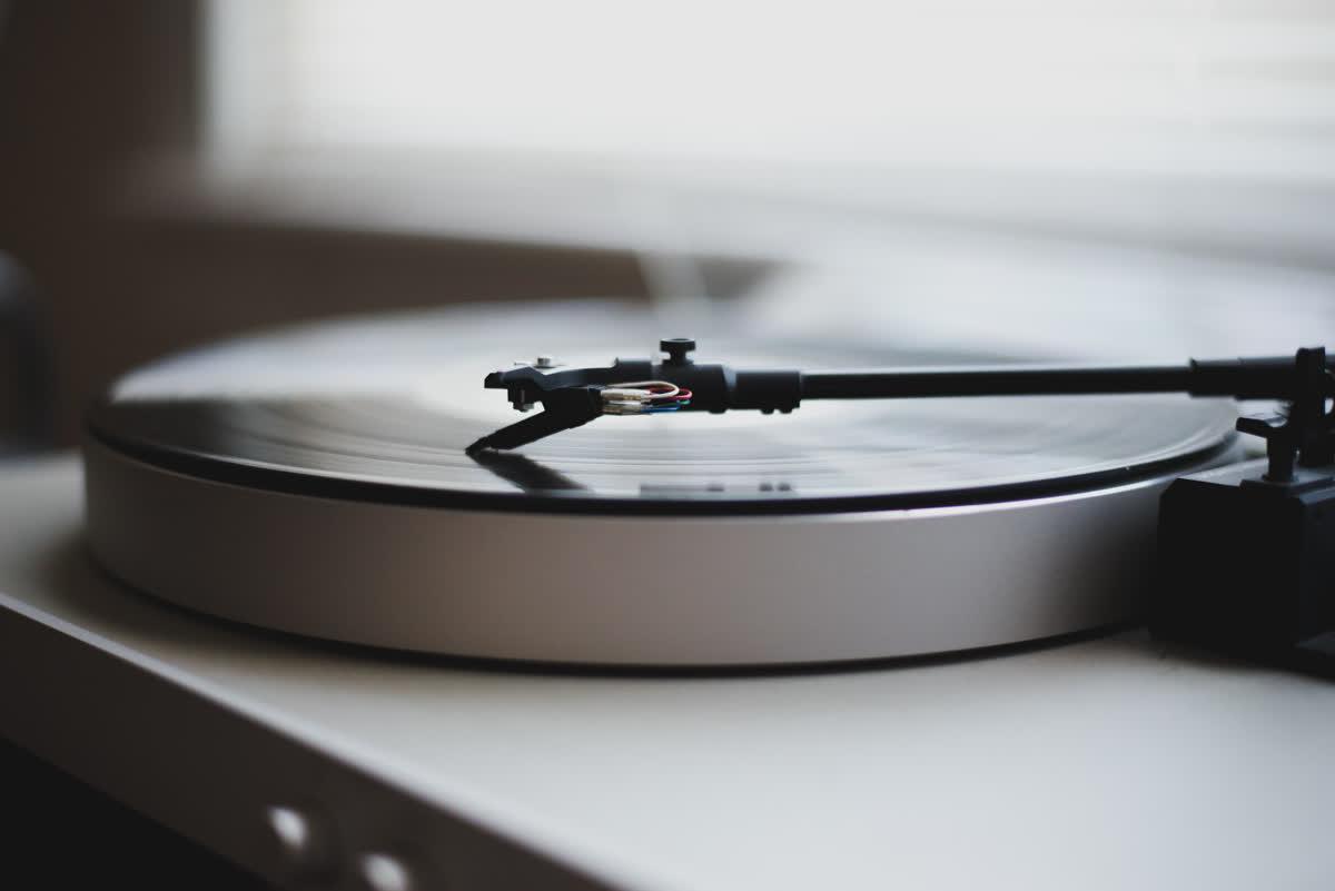 A record turning on a silver turntable